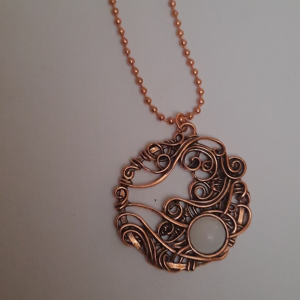 Copper swirl pattern pendant on beaded copper necklace